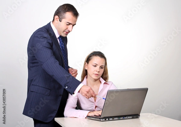 Fototapeta  A male colleague offering a suggestion to a female coworker.