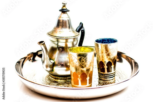 Fototapeta Group of teapot and glasses of oriental tea on a tray on white background