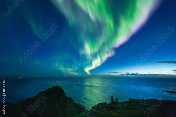 Fototapeta Beautiful night sky with Aurora Borealis aka northern lights in the fjords in Norway.