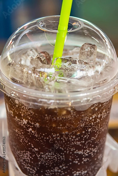 Obraz aerated soft drink with ice in plastic glass