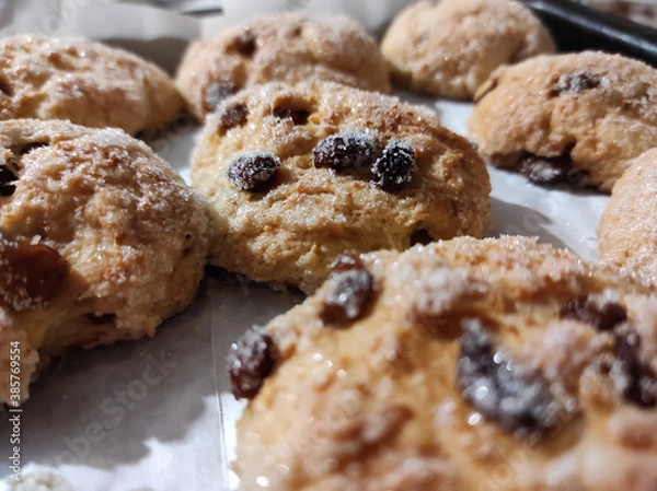 Fototapeta Homemade cottage cheese cookies with raisins sprinkled with sugar close-up.