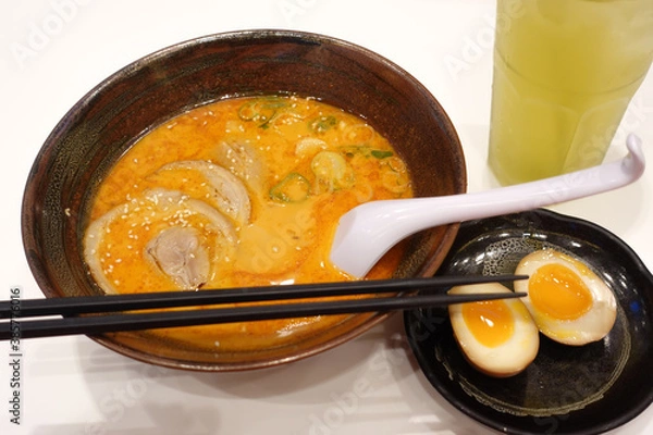 Fototapeta Shoyu ramen, Japanese noodle with pork, soft boiled egg and seaweed on the wooden table