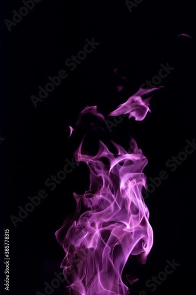Obraz Close-up vertical picture of an isolated bright purple flame with numerous of tongues on the black background 