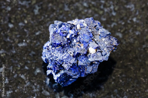 Fototapeta macro photography of sample of natural mineral from geological collection - raw Azurite mineral crystals from Jezkazgan, Kazakhstan on black granite background