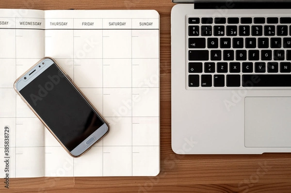 Obraz Telework or study space. Blank organizer, laptop and mart phone. Top view.