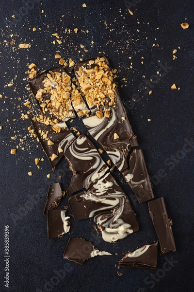 Obraz Dark chocolate bark isolated on a dark background. Top view, flat lay.