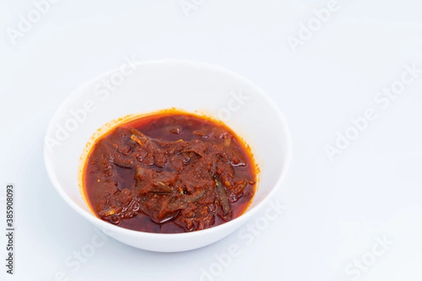 Fototapeta "Sambal ikan bilis" suitable for nasi lemak or nasi impit Asian Inspirations, Stir-Fried Anchovies with hot chilies. A white background provides copy space to the right.