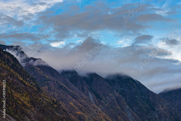 Fototapeta panoramic view of picturesque snowy mountains tops on blue sky background