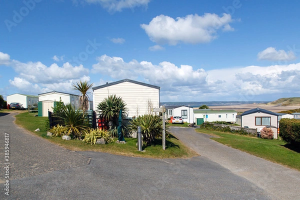 Obraz Caravan Park - static caravans in Gower with a panoramic format and a blue sky background.