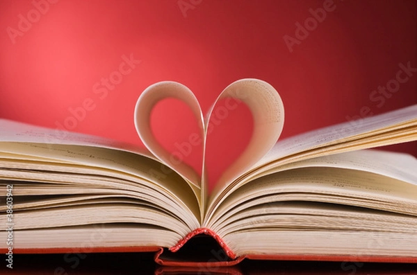 Fototapeta pages of a book curved into a heart shape