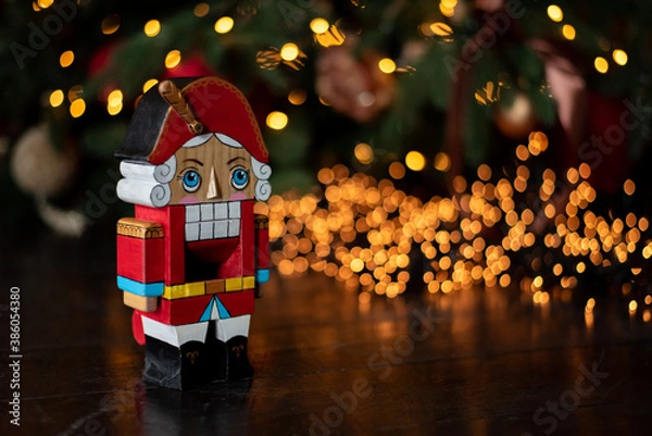 Obraz Decorated Christmas tree on blurred new year's background . children's nutcracker toy stand near the Christmas tree. Happy New Year 2020. winter holidays
