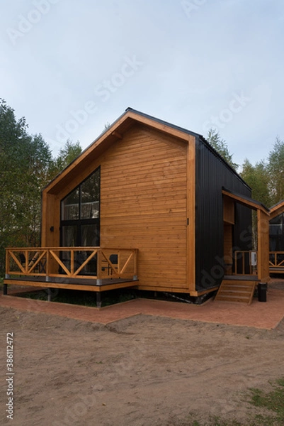 Fototapeta Barnhouse style house. House in the bosom of nature. Greenery and trees.