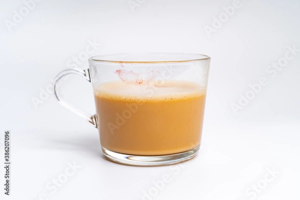Fototapeta Milk tea or popularly known as The Tarik in Malaysia, with a red lip stamped on it isolated on the white background center of the frame
