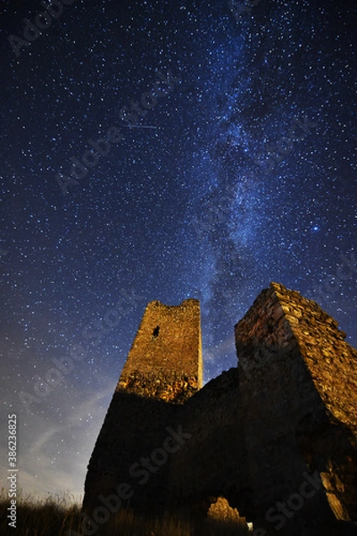 Fototapeta a castle with the milky way in the background