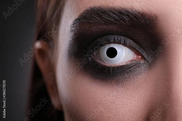 Fototapeta Mysterious witch with spooky eyes, closeup. Halloween party