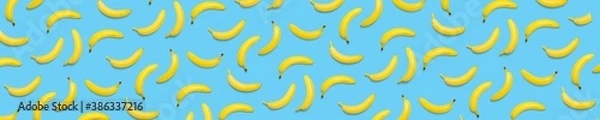 Obraz Bananas creative background. pop art bananas background. Tropical abstract background with banana. Colorful fruit yellow banana