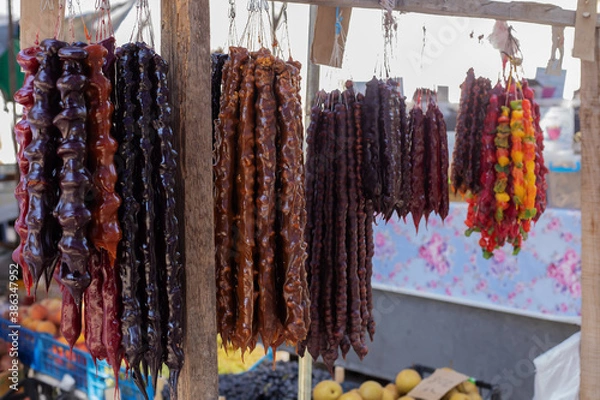 Fototapeta Traditional Georgian homemade sweets with hazelnuts, walnuts, grape juice and honey or sugar. (churchkhela)