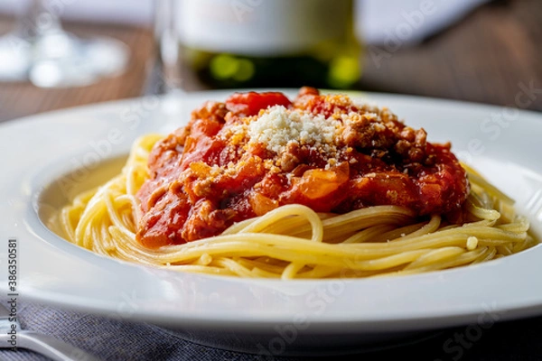 Fototapeta Pasta with meat and tomato sauce on wooden table.
Italian food concept.
