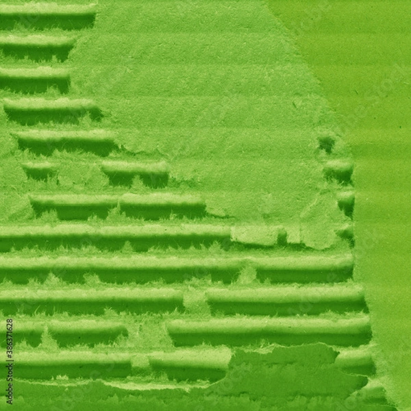 Fototapeta A green vintage rough sheet of carton. Recycled environmentally friendly cardboard paper texture. Simple and bright minimalist papercraft background.