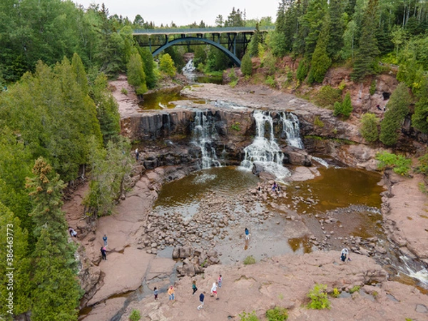 Fototapeta Aerial View of Gooseberry Falls, MN Showing Waterfalls, Fir Trees and Bridge on Summer Day.