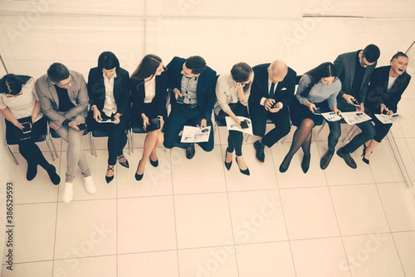 Fototapeta top view. Manager discussing business schedules with company employees