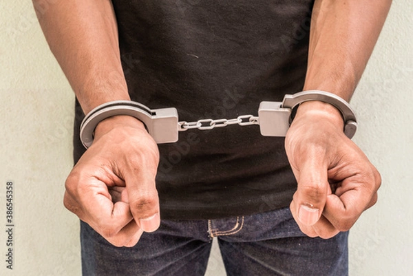 Obraz Concept human trafficking, hand young man in shackle. background look old or vintage style. ( Selective focus )