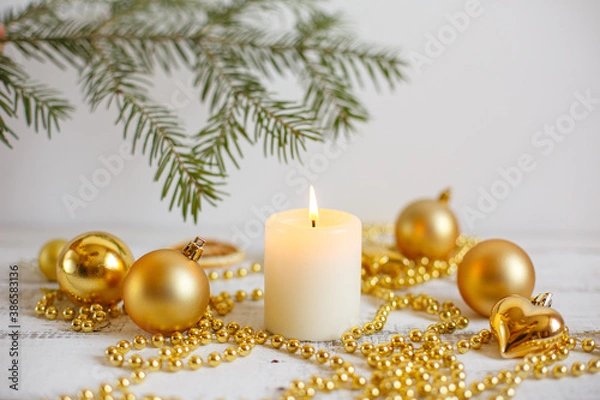 Fototapeta Christmas background, Golden Christmas toys , beads and a burning candle. Greeting card with Christmas
