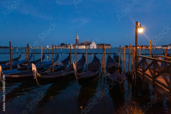 Fototapeta Gondolas in Venice night view from San Marco square in Italy.