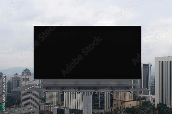 Fototapeta Blank black road billboard with Kuala Lumpur cityscape background at day time. Street advertising poster, mock up, 3D rendering. Front view. Concept of marketing to promote or sell services or ideas.
