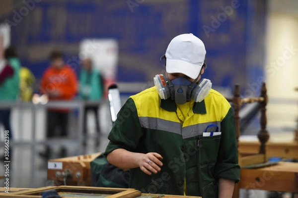 Obraz people in masks are working on projects indoors