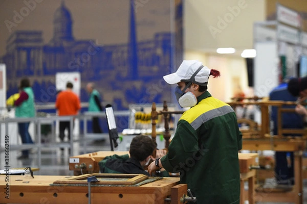 Obraz people in masks are working on projects indoors
