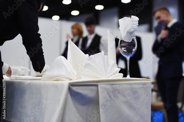Obraz a glass with a napkin is on the table covered with a tablecloth