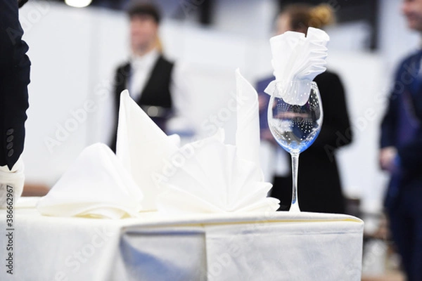 Obraz a glass with a napkin is on the table covered with a tablecloth
