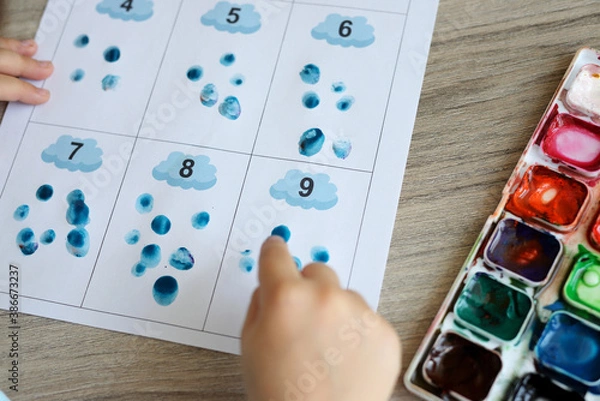 Obraz Montessori material. Children's hands. The study of mathematics and seasons. School and kindergarten. early development of children. preparation for school