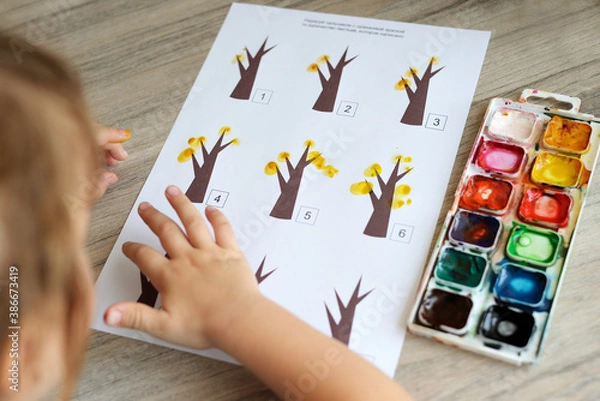Obraz Montessori material. Children's hands. The study of mathematics and seasons. School and kindergarten. early development of children. preparation for school