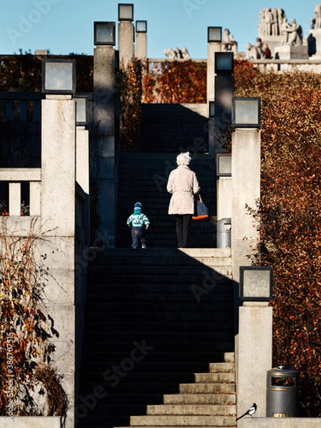 Obraz Grandmother and grandson in a public park. 