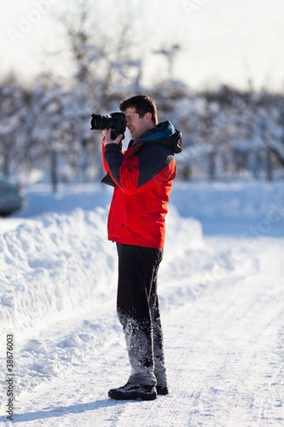 Fototapeta Tourist with camera in the winter