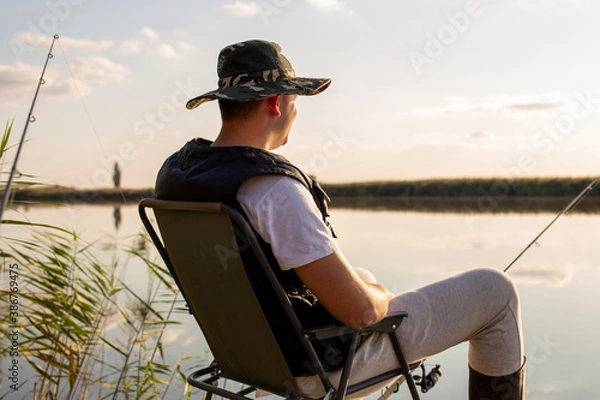 Fototapeta a man fishing on the dock