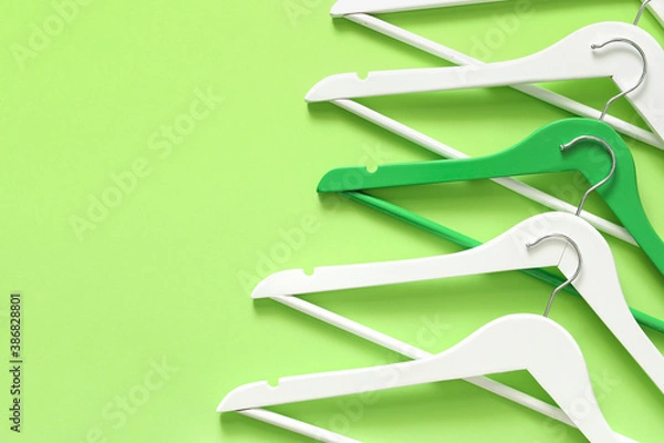 Fototapeta Clothes hangers on color background