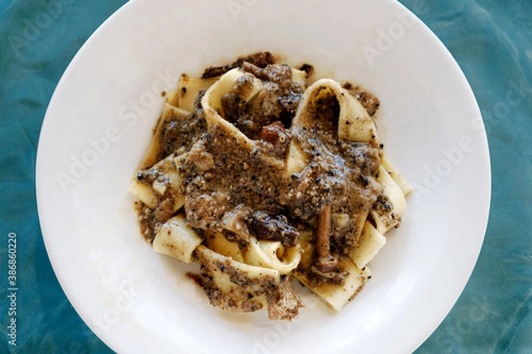 Fototapeta Top view of pappardelle pasta dish with dish truffle and mushrooms a typical Italian plate from Abruzzo region