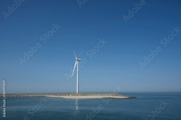 Fototapeta Windmill on the coast of the Netherlands producing renewable energy for a sustainable future