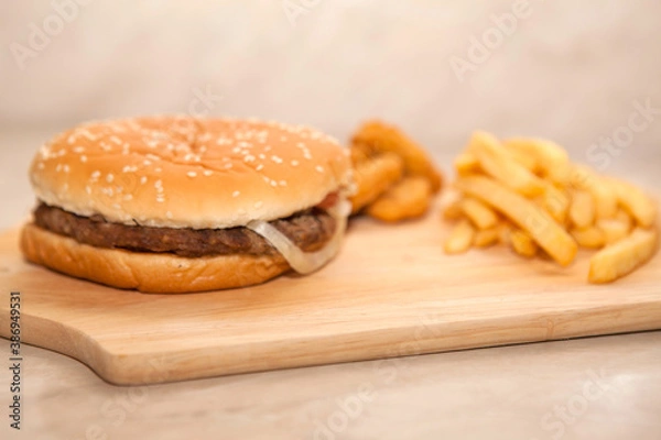 Obraz Close up of tasty burger with french fries on cutting board