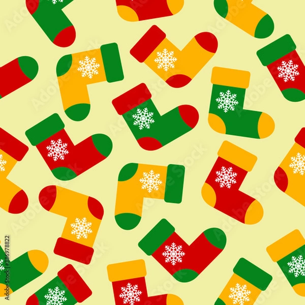 Fototapeta Colorful christmas socks with snowflackes on light yellow background. Red, green and yellow socks. Seamless pattern, vector graphics. Print for wrapping paper, fabric, background. ornament.