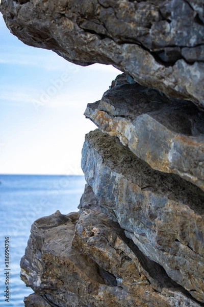 Fototapeta Textured rock. Layers of stones on the background of the sea. Close-up