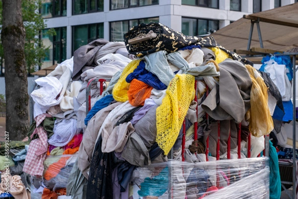 Fototapeta Pile of old clothes dumped in a container
