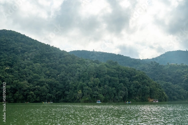 Fototapeta View from Lake Phewa, in Pokhara (Nepal), on the banks of the Anadu hill and the Shanti stupa (Peace Pagoda) on it