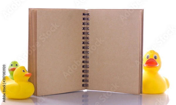 Fototapeta spiral craft notebook for business concept with ducks on white background