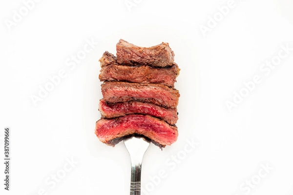 Fototapeta 
Different degrees of doneness of steak on a fork for meat on a white background