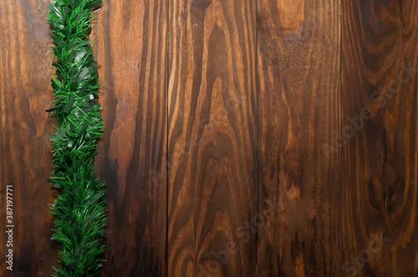 Obraz Christmas or New Year decoration background: pine branches, on rustic and dark wooden background and with space for text. Minimalist background. View from the top