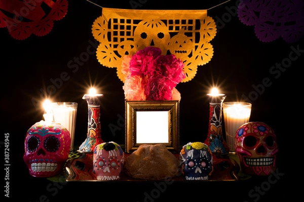 Fototapeta Day of the Dead offering from central Mexico with papel picado, veladoras, photography, flowers and bread of the dead